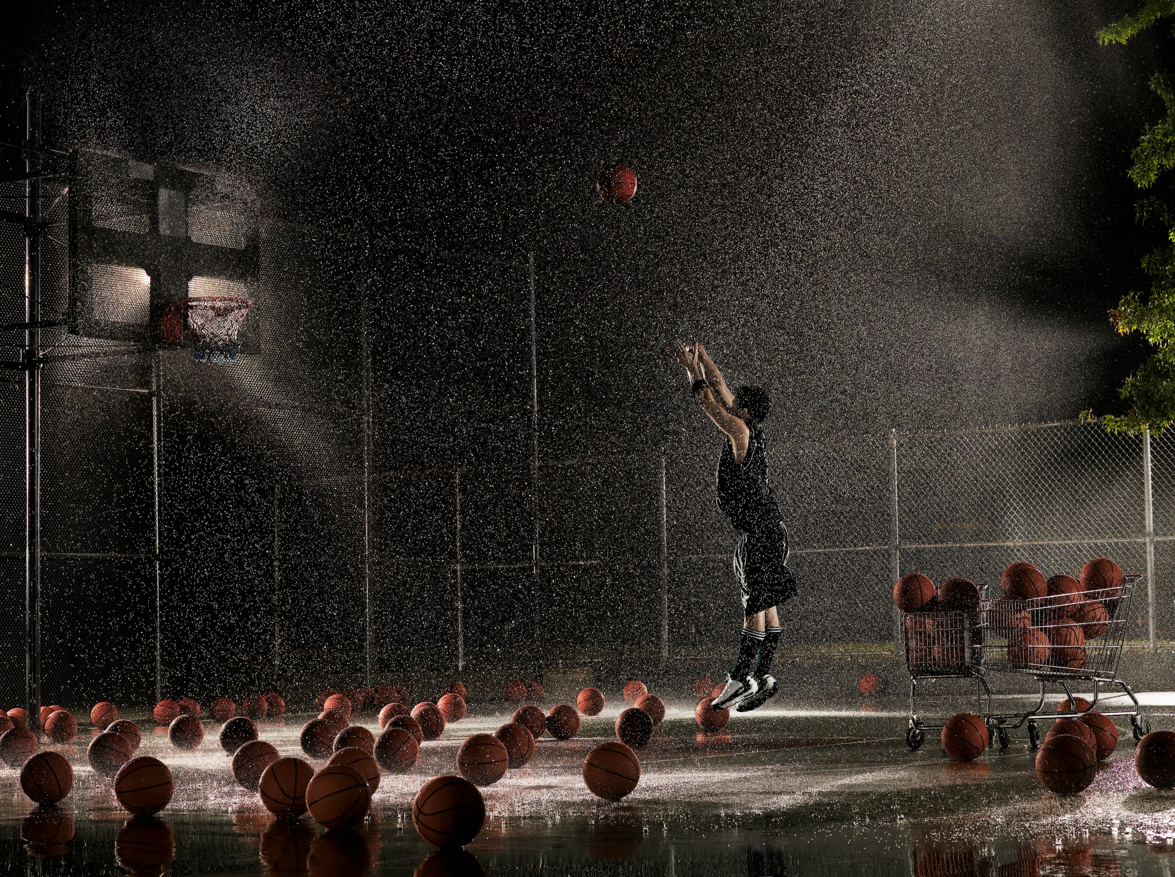 Basketball player training in the rain